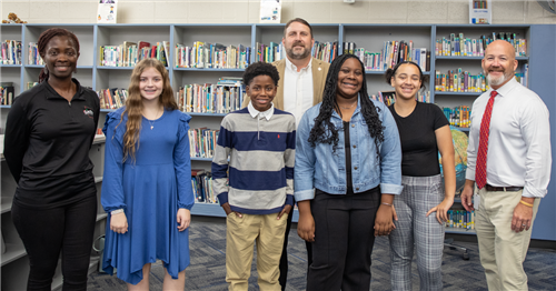 REACH Scholars smiling at the camera with Mr Lowe Dr Hyatt and Coach Glass