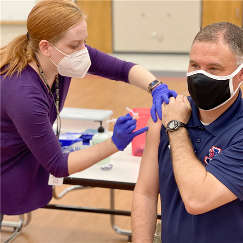 Dr Simpson receiving the COVID vaccine 