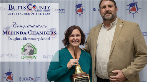 Mrs. Chambers with Mr. Lowe smiling at the camera