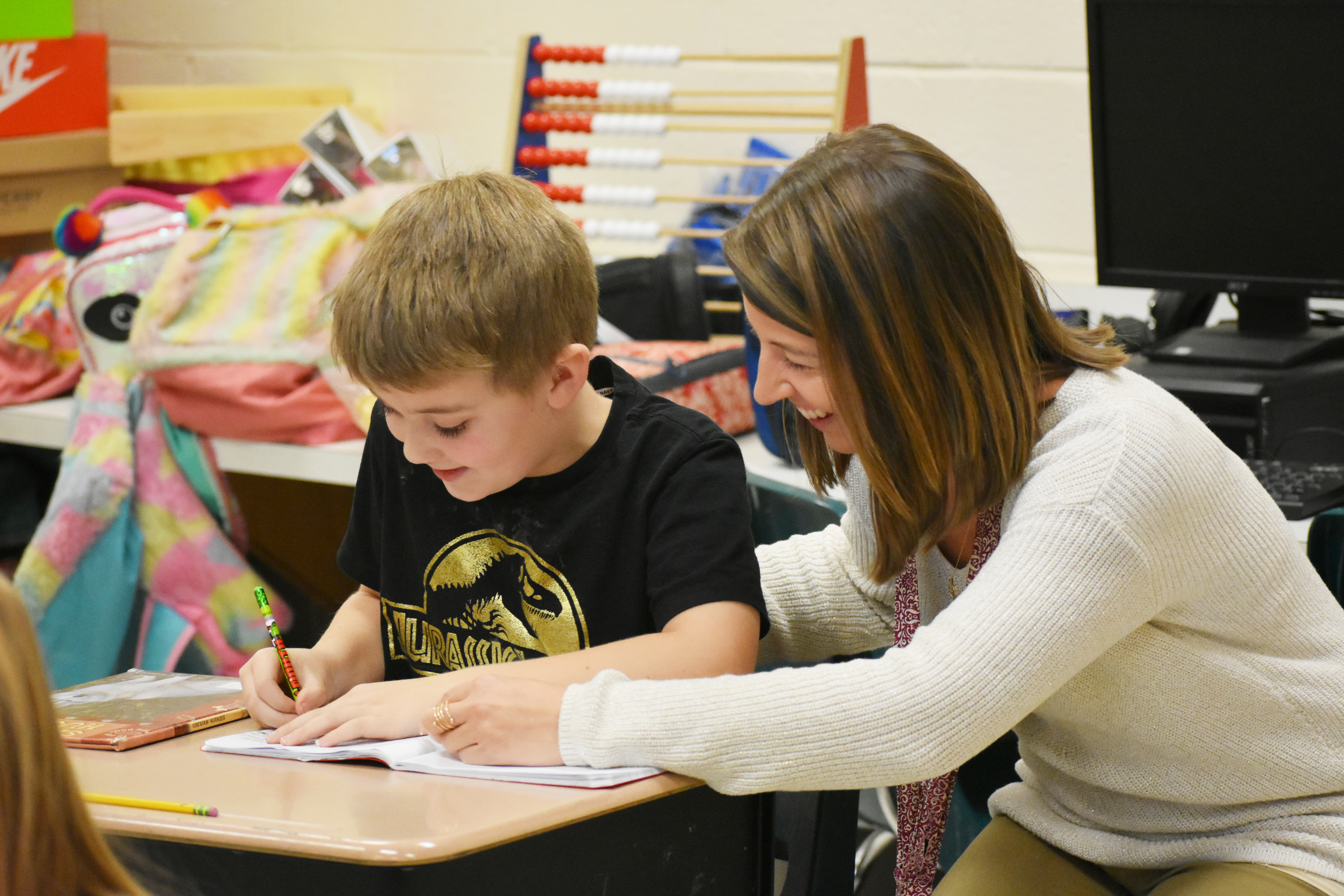 teacher helping student 